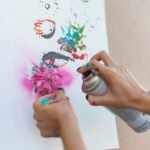 artist-painting-with-spray-bottle